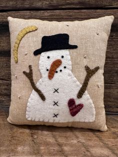 a pillow with a snowman on it