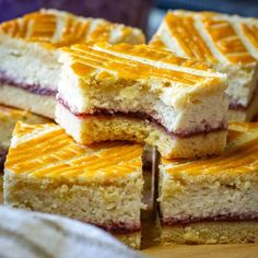 several pieces of cake sitting on top of a wooden cutting board next to each other