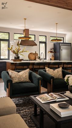 a living room filled with furniture next to a kitchen and dining room table covered in flowers