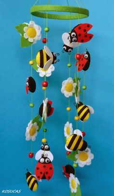 a mobile made to look like a ladybug, bee and flower wind chime