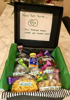 a box filled with snacks sitting on top of a table next to a sign that says new that year