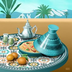 there is a blue vase on the table with oranges and a tea pot next to it