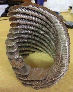 a stack of coins sitting on top of a table next to a pile of money