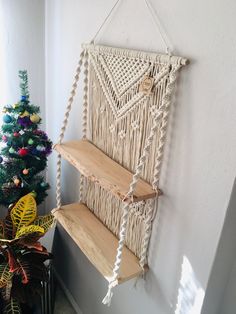 a macrame wall hanging next to a christmas tree