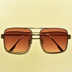 These 1970s vintage style sunglasses feature an oversized square lens, are outlined with a chic gold rim, provide UV 400 protection and comes in three translucent colors. Each sold separately. Dimensions: Length: 6 inches Lens diameter: 2.2 inches Retro Square Frame Metal Sunglasses, Trendy Gold Square Frame Aviator Sunglasses, Retro Gold Square Frame Sunglasses, Retro Gold Shield Sunglasses With Gradient Lenses, Retro Square Frame Aviator Sunglasses For Summer, Gold Retro Sunglasses For Summer, Retro Gold Sunglasses For Summer, Gold Retro Summer Sunglasses, Retro Gold Shield Sunglasses With Uv Protection