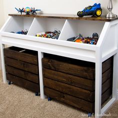 the toy chest is made out of wood and has three bins with toys in them