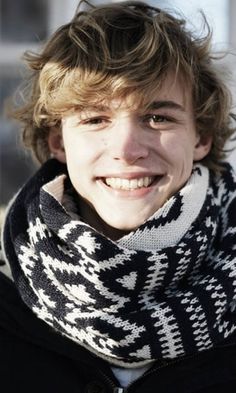 a young man wearing a black and white scarf