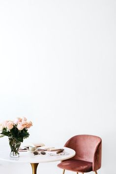 two chairs and a table with flowers on it