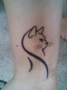 a cat's head on the ankle with black lines and a small outline in it