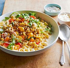 a white bowl filled with pasta and vegetables