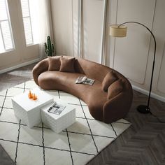 a living room with a couch, coffee table and other items on the rugs