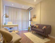 a living room filled with furniture and a flat screen tv mounted to the side of a wall