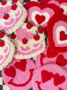 crocheted heart coasters and pot holders on a checkered tablecloth pattern