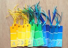 the name tags are attached to each other by string and colored paper with clips on them