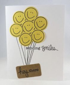 a greeting card with smiley face balloons on it