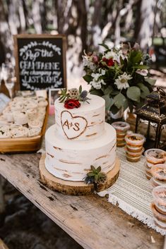 a table topped with a white cake covered in frosting