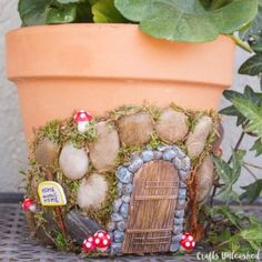 a potted plant with a fairy door in it