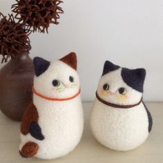 two stuffed cats sitting next to each other