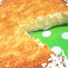 a piece of cake sitting on top of a green and white polka dot table cloth