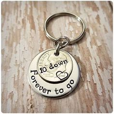 a silver keychain with the words, 10 down forever to go on it