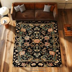 an overhead view of a living room with a couch, coffee table and rug on the floor