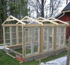 a house being built in the yard with windows on each side and an attached porch