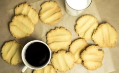 some cookies are next to a cup of coffee