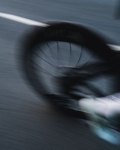 blurry image of a bicycle wheel on the road with no wheels or spokes