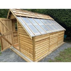 a small wooden shed with a metal roof