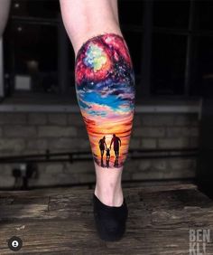 two people standing on top of a wooden table under a colorful sky and stars tattoo