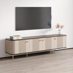 a tv mounted on the wall in an empty room with wooden floors and white walls