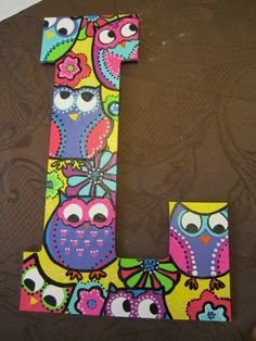 the letter l is decorated with colorful owls