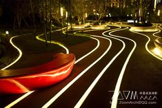 a curved road with lights on it at night