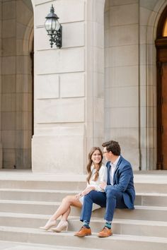 a man and woman sitting on steps next to each other