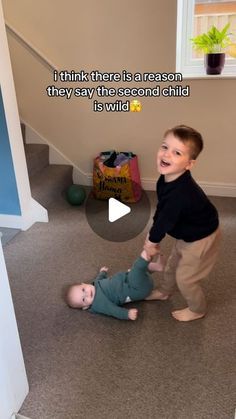 a little boy is playing with another kid on the floor in front of him and saying, i think there is a reason they say the second child is wild