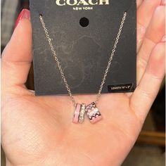 Brand New Coach Necklace. Never Opened Or Worn, Silver Chain, Pink Hoops And One With Design. One Silver Hoop Has Diamonds. Coach Rose Gold Jewelry For Gifts, Coach Necklace With Adjustable Chain For Gift, Coach Necklace With Adjustable Chain As Gift, Silver Coach Jewelry For Gift, Coach Silver Jewelry For Gift, Coach Sterling Silver Jewelry As A Gift, Coach Sterling Silver Jewelry, Coach Silver Jewelry, Coach Necklace