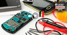 a cell phone is being soldered and surrounded by tools