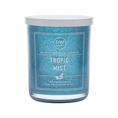 a blue candle that says tropical mist