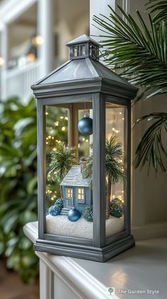 a small house in a glass lantern on top of a mantle