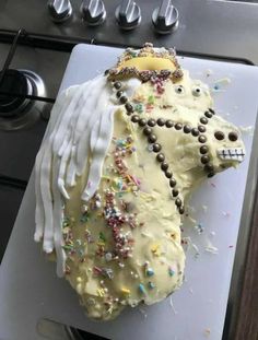 a cake shaped like a horse with icing and sprinkles on it