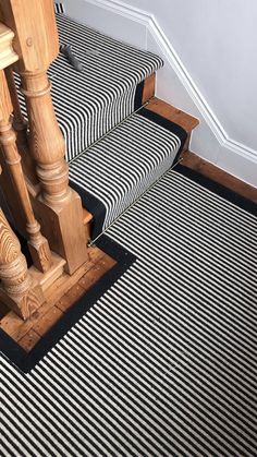 a stair case with black and white striped carpet