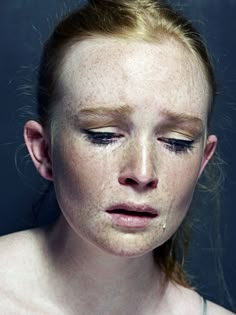 a woman with freckles on her face