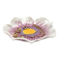 a purple and yellow flower shaped dish with gold accents