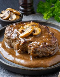 a hamburger covered in gravy and sliced bananas