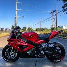 a red motorcycle is parked on the street