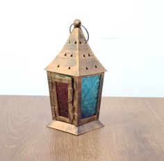 a small wooden lantern sitting on top of a table