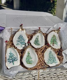 six porcelain christmas ornaments in a wicker basket