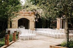 rows of white chairs set up for an outdoor ceremony