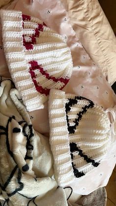 several knitted items laying on top of each other