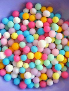 colorful candy balls in a purple bowl